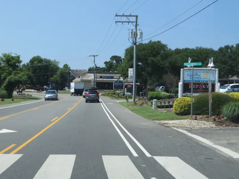 View of Duck town center with commercial buildings, shops, and the characteristic small-town coastal village feel along NC 12