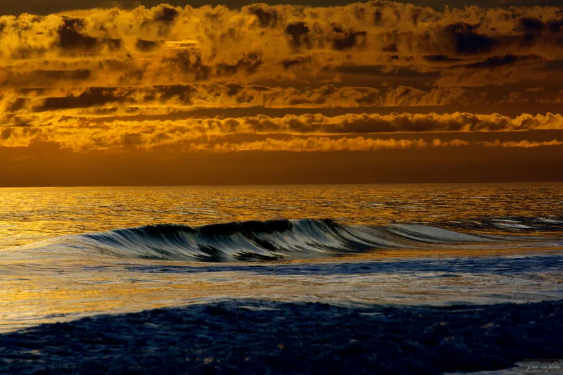 Golden hour weather over the Atlantic at the Southern Outer Banks with dramatic clouds and light