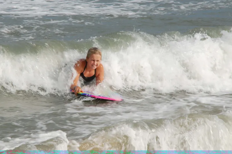 Ocean waves rolling onto the beach on Hatteras Island, with foamy whitewater reaching up the sand