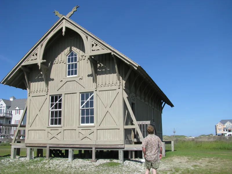 The historic Chicamacomico Life-Saving Station building in Rodanthe, a red-roofed wooden structure from the early 20th century on the Outer Banks