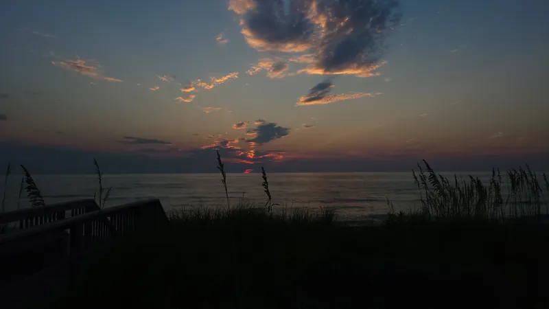 Birthday sunrise at the Outer Banks with rich orange sky over calm ocean