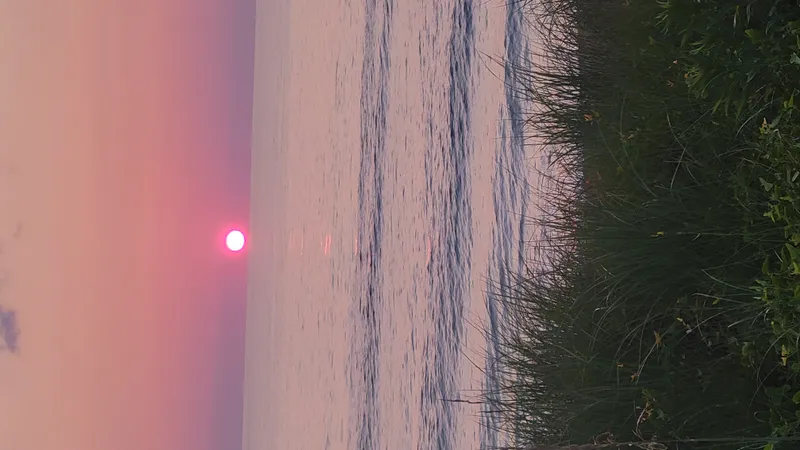 Sunrise light spreading across the ocean at the Outer Banks near Kitty Hawk