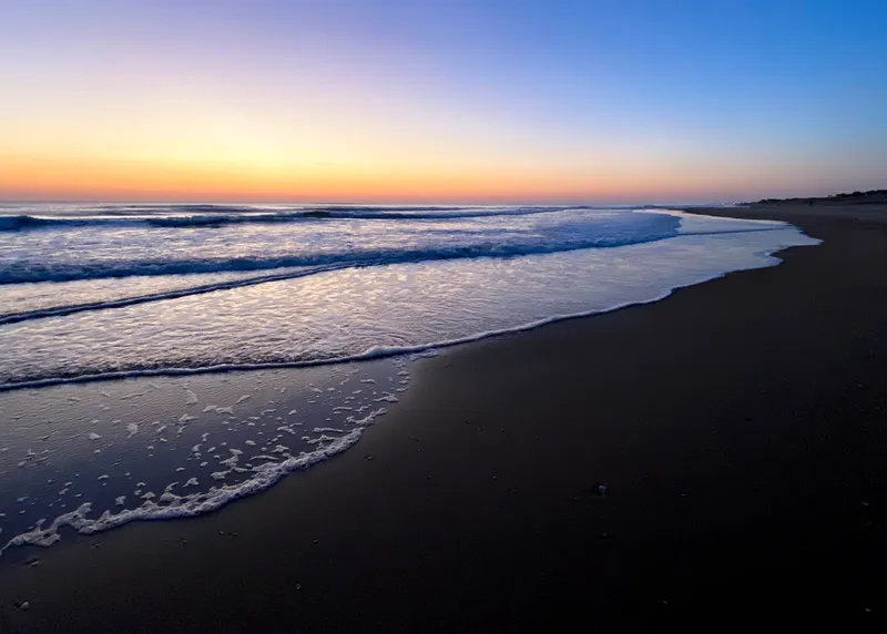 Sunrise over the ocean at Nags Head with pink and gold clouds